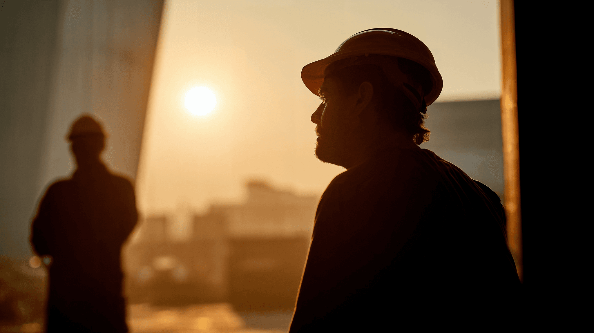 Construction worker silhouette with sunset background