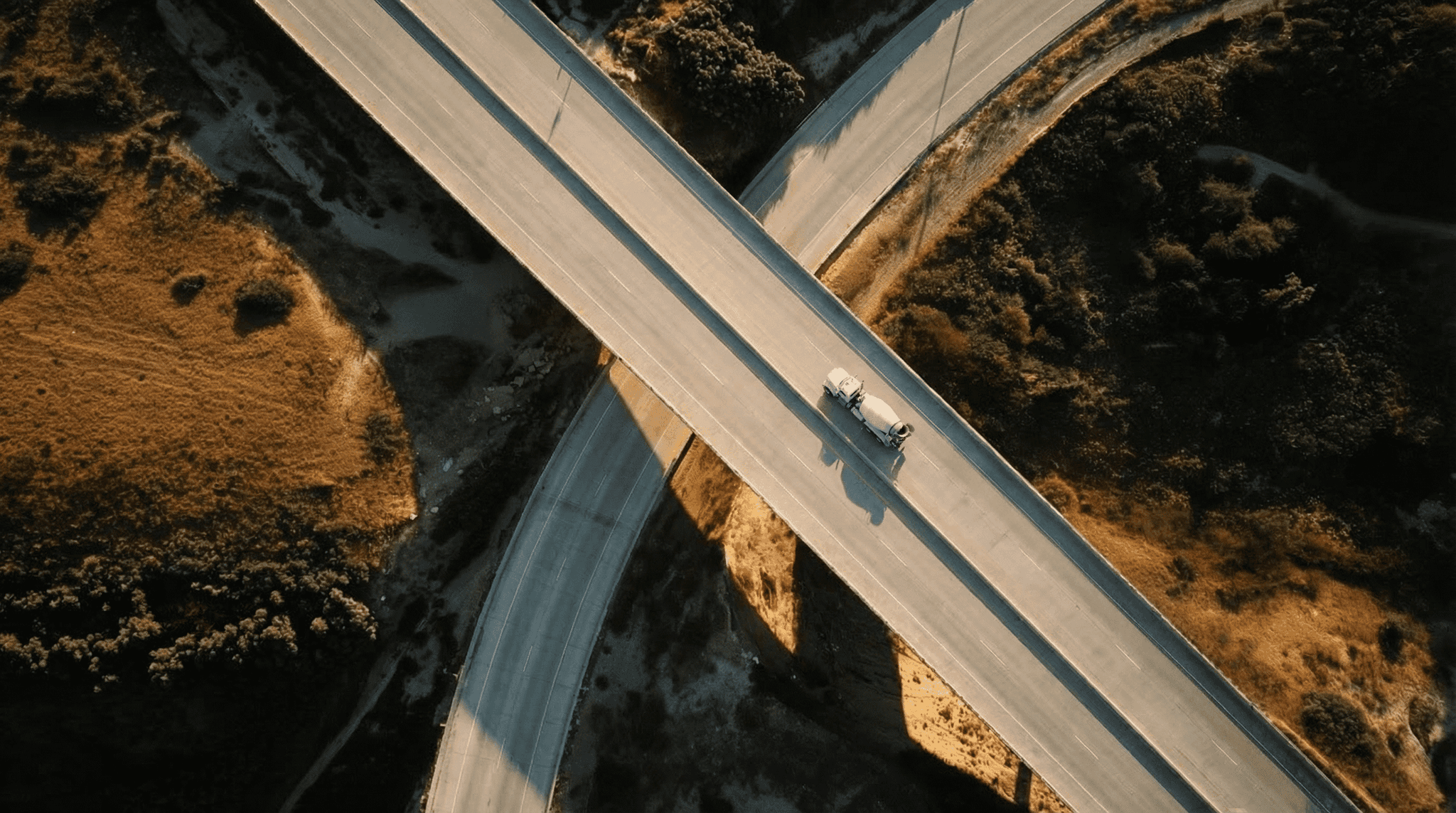 An aerial view of a complex highway interchange with multiple overpasses and merging lanes.